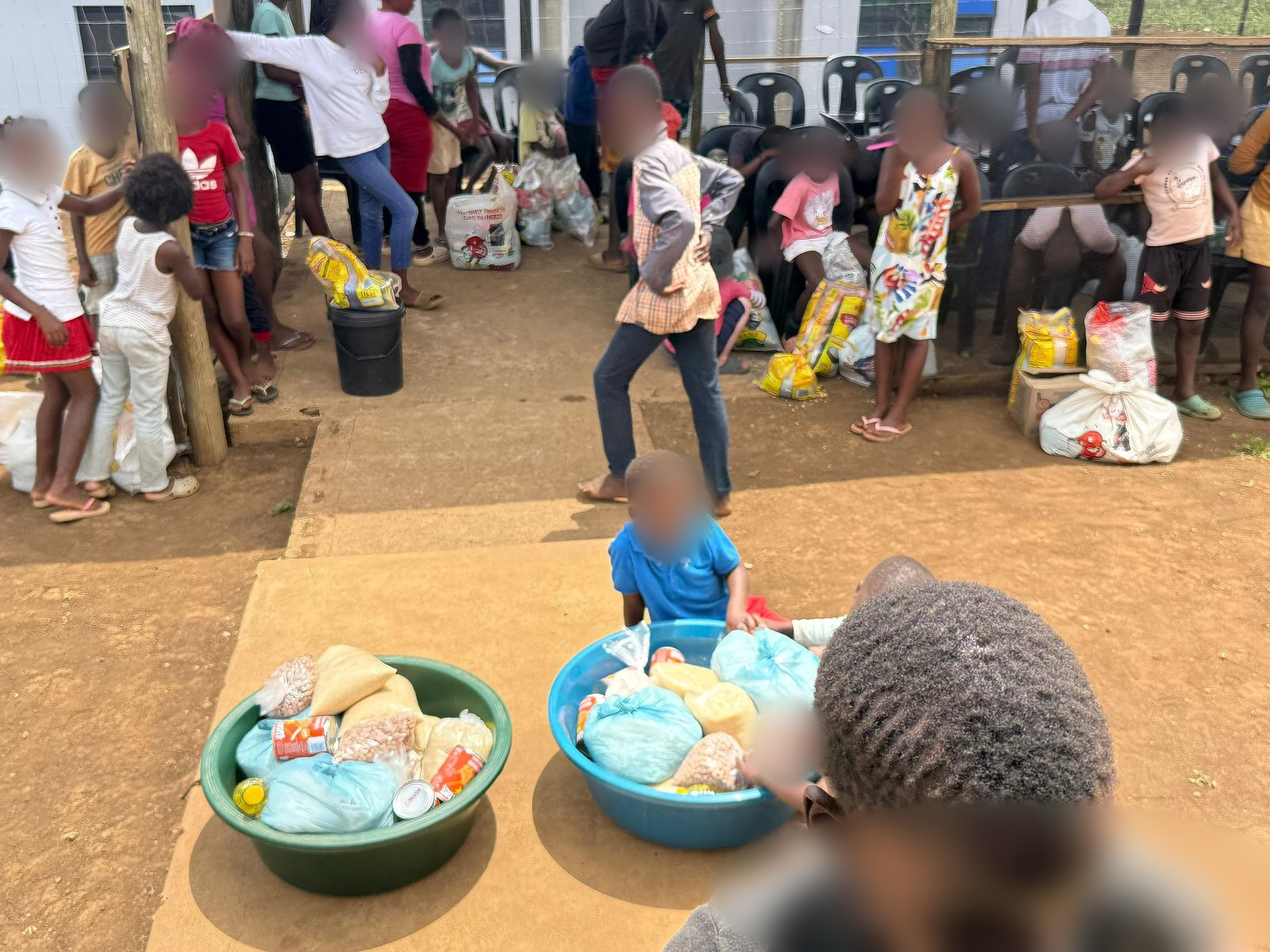 Children sorting food parcel staples at the soup kitchen